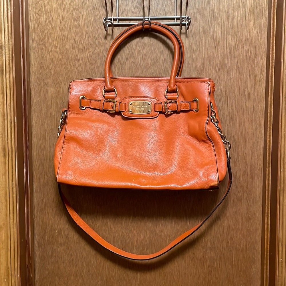 Michael Kors orange purse with long strap